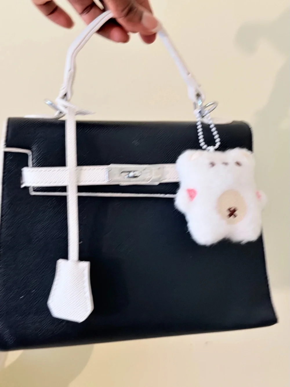 Black and White Structured Top-Handle Bag with Plush Charm